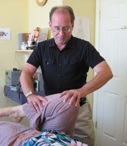 Dr. Erskine DO treating a patient with Osteopathy
